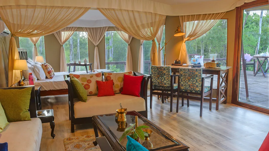 Inside the Chief's Tent: sofas, a dining table and the bed beneath draped canvas
